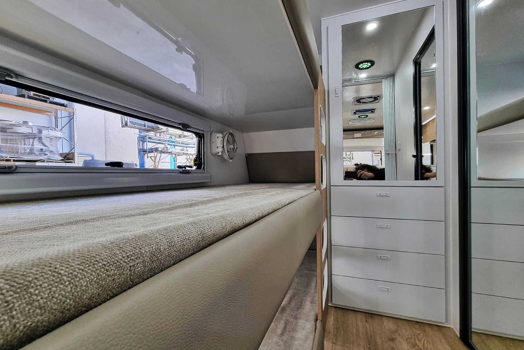 Elegant Royal Flair Aussiemate caravan with inviting kitchen seating, luminous interior, and integrated storage compartments