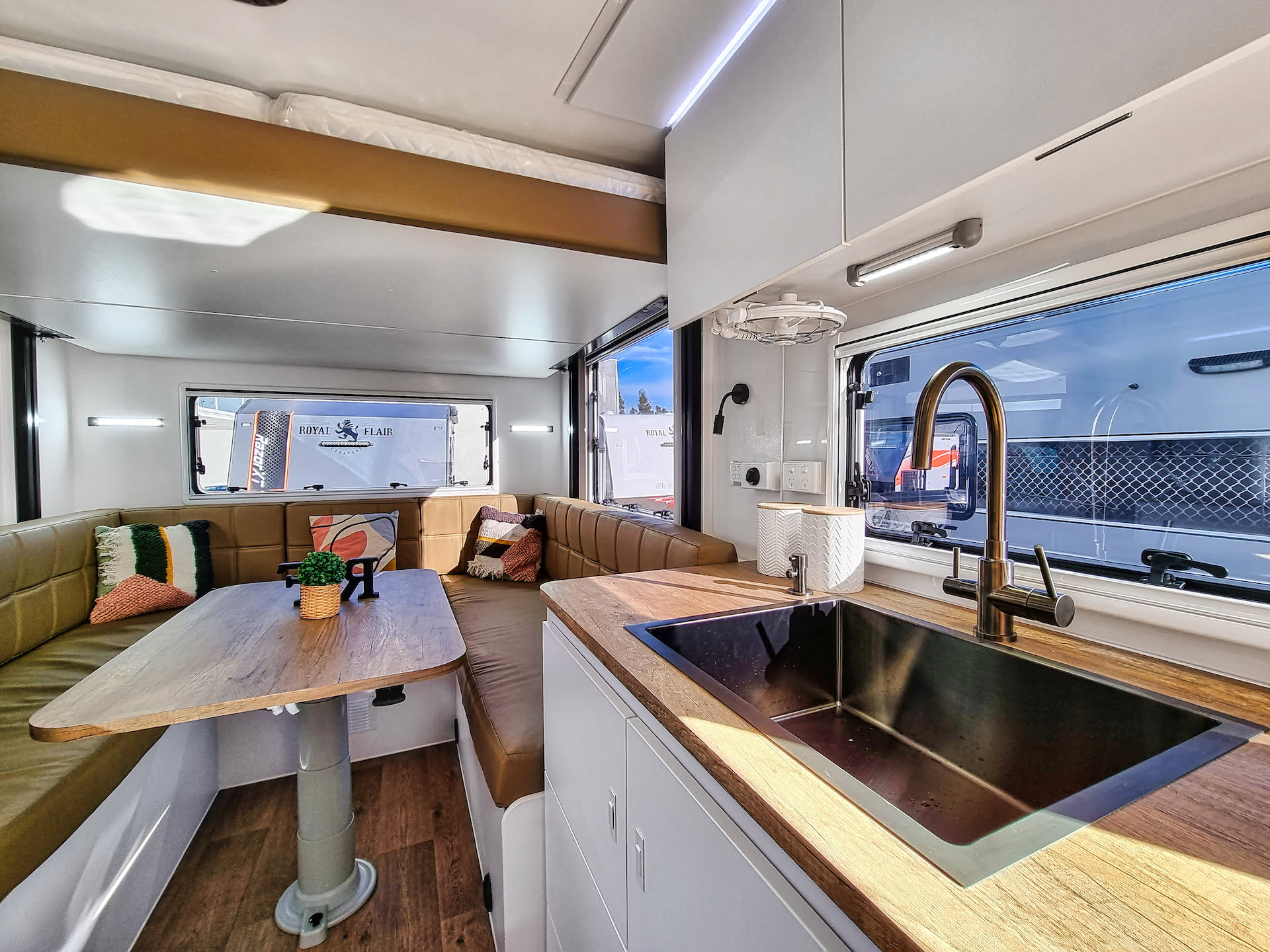 The Aussiemate caravan's interior features a versatile dropdown bed, merging luxury with smart design